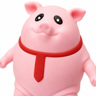 Close-up of the pink pig squeeze toy's face, snout, and red necktie