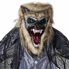 Close-up of the animated werewolf prop head: snarling grey face, red open mouth with fangs and faux-fur mane