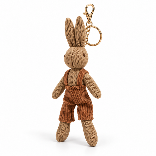 Knitted rabbit keychain in brown corduroy overalls, three-quarter view on white with gold clasp