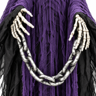 Close-up of the Grim Reaper prop skeletal hands holding the silver chain over the tattered purple and black robe