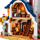 Close-up of the brick-built owl cottage interior with bedroom, staircase, candle table and glowing round window