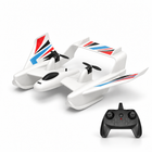 Amphibious RC plane boat with its remote controller on a white studio floor