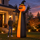 10-foot inflatable pumpkin ghost Halloween decoration beside an adult for scale at dusk