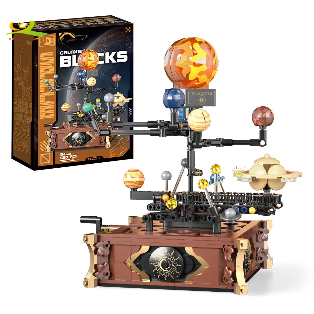 697PCS mechanical solar system building model displayed alongside its Galaxies Blocks packaging box.