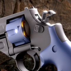 Close-up view of the TB-500 Dart Revolver showing the blue rotating cylinder and trigger details.