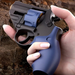 Hand holding the TB-500 Blue Dart Revolver, showing trigger and grip details.