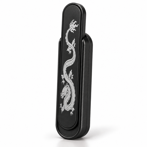 Black metal magnetic push card fidget with engraved dragon, standing upright on white