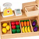 Close view of wooden market counter, toy scale, card reader and produce compartments
