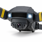 Close-up of the foldable RC drone front camera, LED lights, and yellow-striped arms