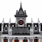 Close detail of the hospital model's central red clock face, black spire, and roofline turrets