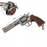 Gunmetal alloy revolver keychain with brown grip, rotating cylinder and 7cm size reference
