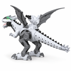 Square rear three-quarter studio view of the white robot dinosaur showing its segmented tail, wings, legs and back launcher