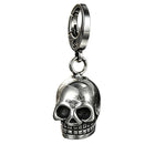 Silver stainless steel skull keychain standing upright on a clean white background showing its reflective metallic finish.