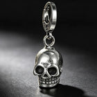 Close-up view of the heavy-gauge flat silver stainless steel split ring connected through the skull's top bail loop.