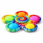 Single rainbow flower pop spinner viewed from a low side angle, showing its rim and raised spiral hub on white.