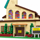 Close detail of the Springfield church model's colorful stained-glass windows and front entrance