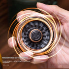 Macro photograph displaying the high-speed rotational blur and luminous glowing halo of the Star Ring spinner.