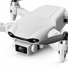 Detail of the light-gray quadcopter nose, two front lamps and single square camera.
