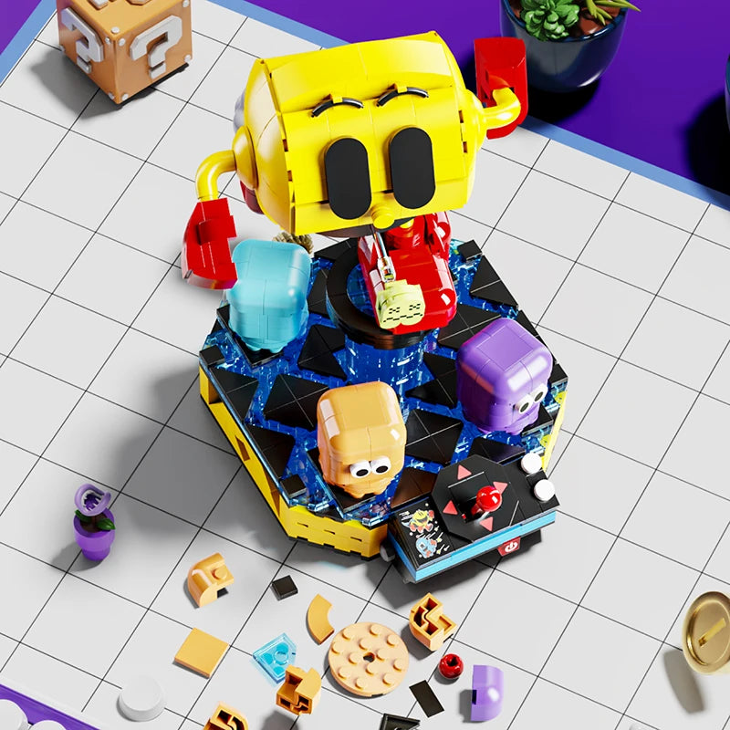 Top view of Pac-Man building block figure with rotating ghost characters on display base, surrounded by extra brick pieces – Toylvia model set