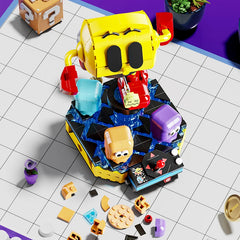 Top view of Pac-Man building block figure with rotating ghost characters on display base, surrounded by extra brick pieces – Toylvia model set