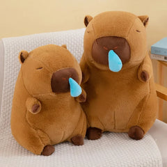 Two cute brown snot capybara plush toys sitting on a chair