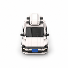White brick-built city hatchback with roof carrier in a straight-on front view on a white studio background.