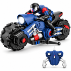 scale-rc-stunt-drift-motorcycle-omni-wheels-rider-blue: left-facing three-quarter studio hero with matching controller.