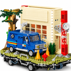 Close view of the cream radio station, broadcast tower, and blue van