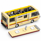 Close-up of the cream brick-built camper van included with the chemistry lab set, showing its red and yellow stripes and open interior.