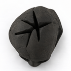 Top view of the black ceramic fire pit skull showing the hollow cross-shaped slot for flames