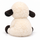 Fluffy cream and black plush sheep sitting, back view