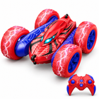 Double-Sided Flip 4WD Drift RC Car in red and blue turned 45 degrees left with its remote controller on a white studio floor