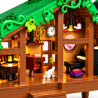 Close-up of the brick-built folk cabin interior with dining table, clock, piano and white cat