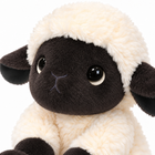 Fluffy plush sheep macro close-up of the face, glossy eyes and wool fringe