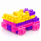 Squishy jelly building blocks vehicle in purple, yellow and pink, seen from the back-left side