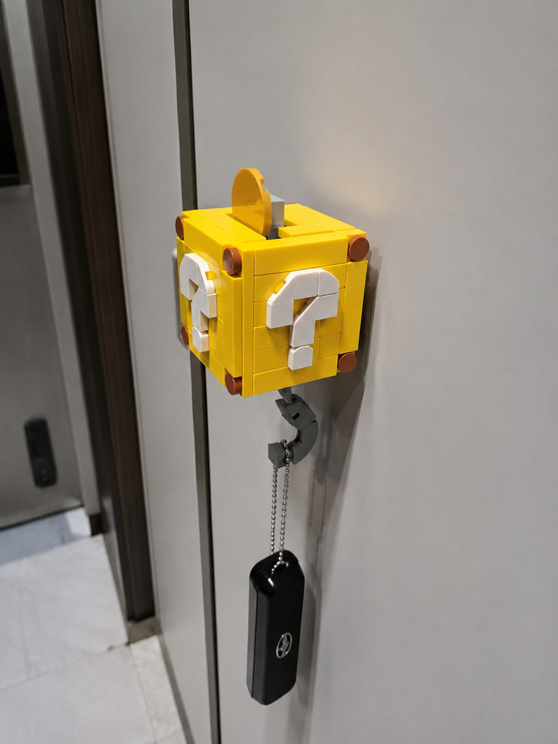 Mystery Question Block key holder mounted on a gaming room wall holding keys