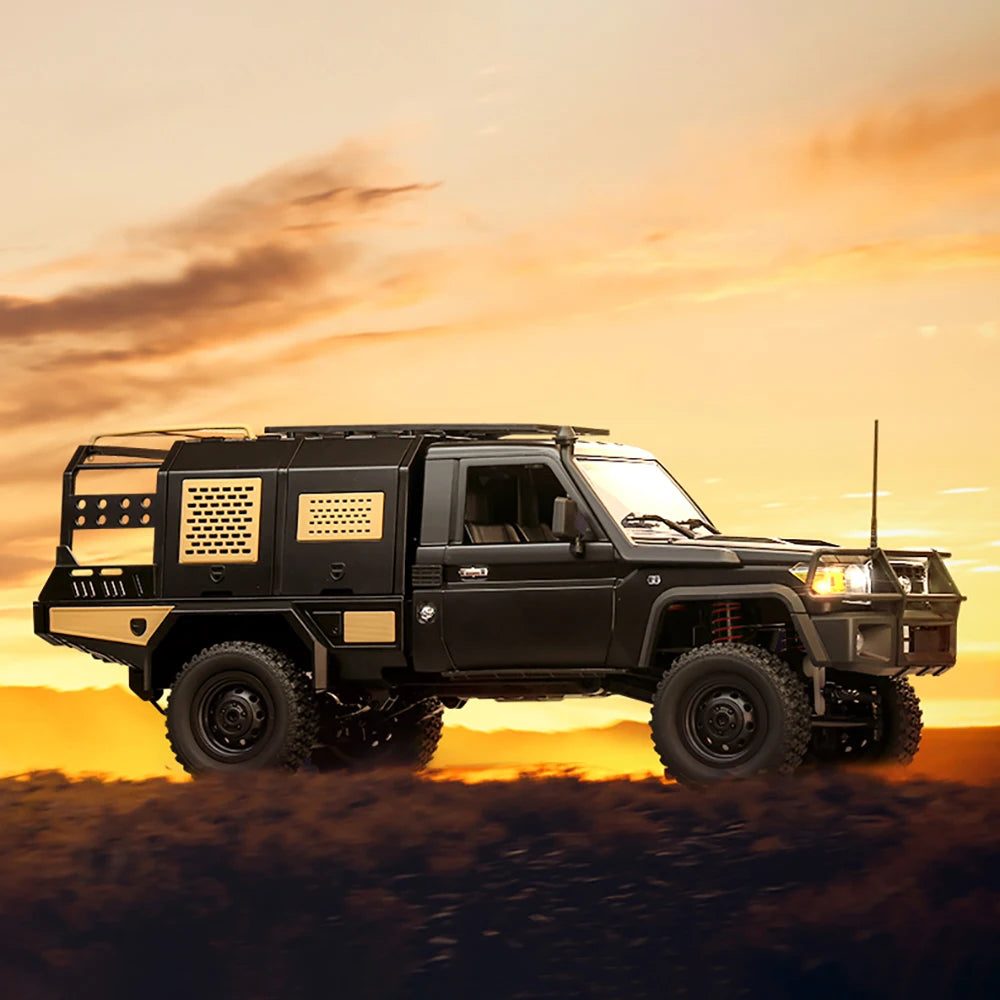 Black off-road vehicle on a desert landscape with a sunset sky