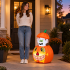 2.8-foot inflatable pumpkin ghost beside an adult for scale at dusk, hands not visible