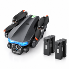 Folded charcoal camera drone shown with two modular flight batteries.