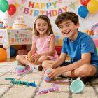 Child and adult hands holding open dragon eggs and posing the colorful articulated hatchlings on a wooden tabletop.