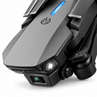 Close-up of the E88 drone front camera, light, and blue top indicator.