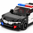 The Urban Defender 318-piece brick police car — close-up of grille, front wheel and emergency light bar on white studio background