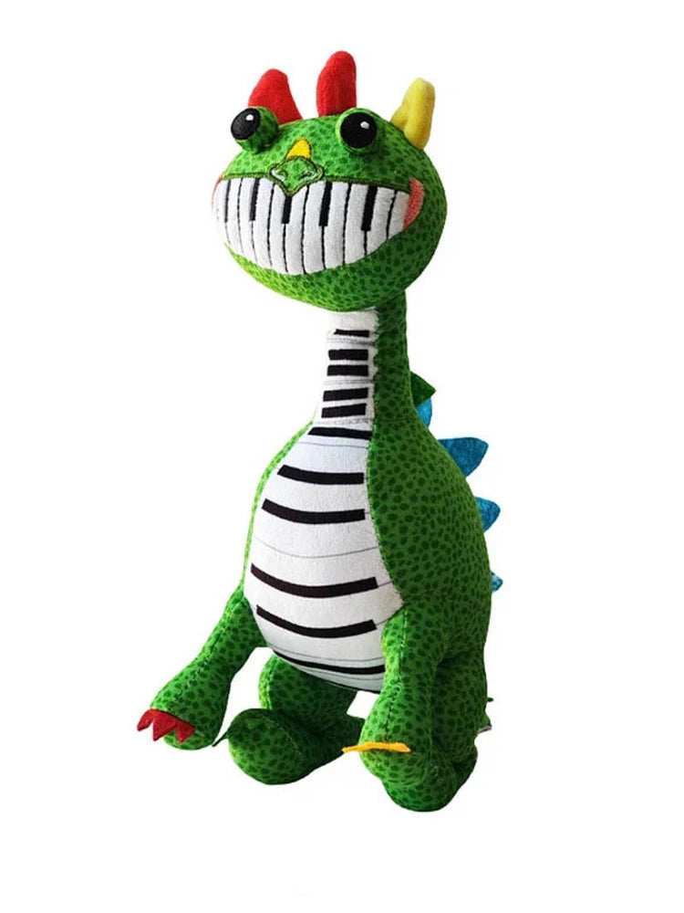 Standing green Pianosaurus plush toy with piano-teeth smile and blue spikes