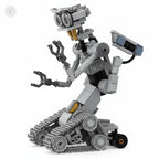 Grey robotic building model standing upright on tracked wheels with articulated arms on a white background