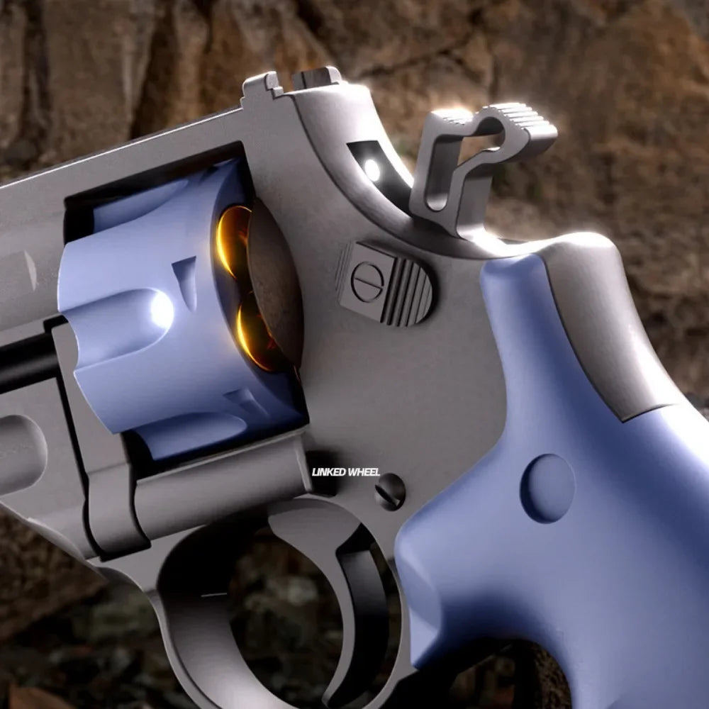 Close-up view of the TB-500 Dart Revolver showing the blue rotating cylinder and trigger details.