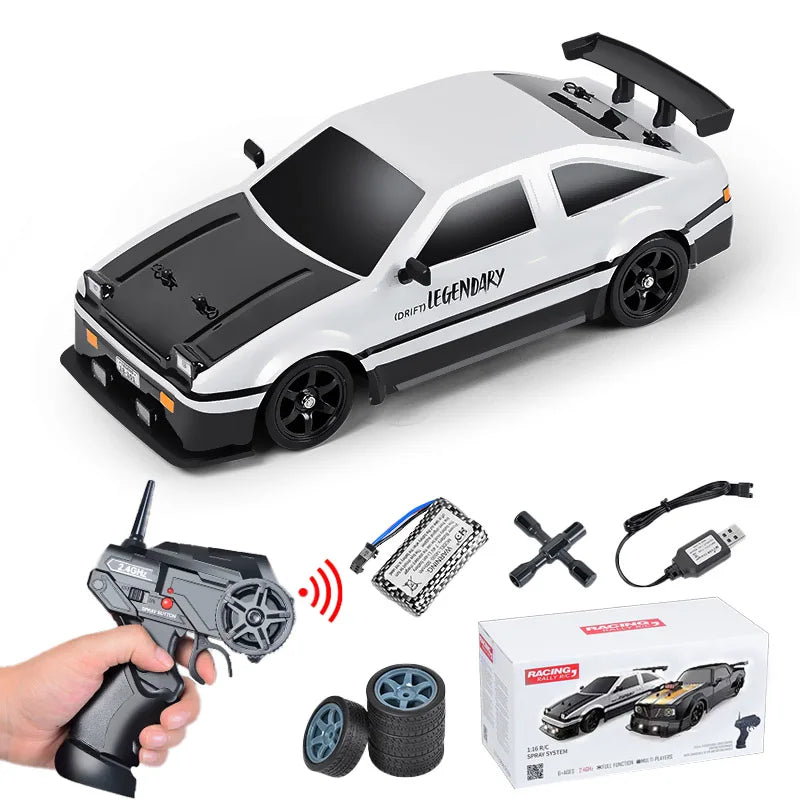 Toy car with remote control, accessories, and packaging on a white background
