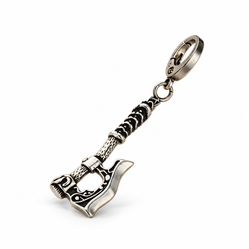 Left-facing three-quarter white studio photo of the antique steel axe pendant keychain, isolated with a soft contact shadow.