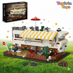 Toy RV model with striped awning on grass, Toyvia Toys branding visible