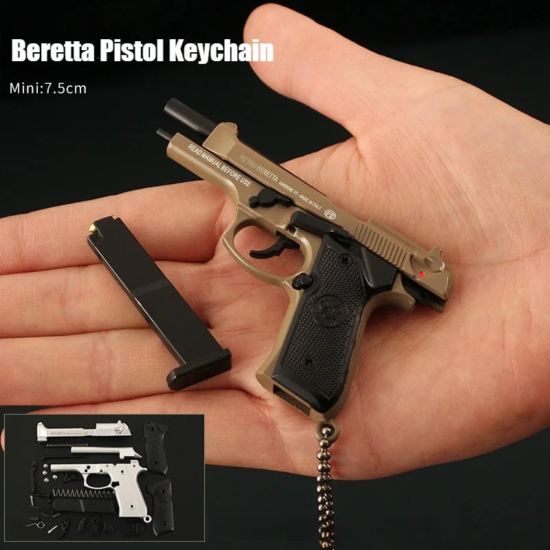 Miniature Beretta pistol keychain held in a hand with a black background