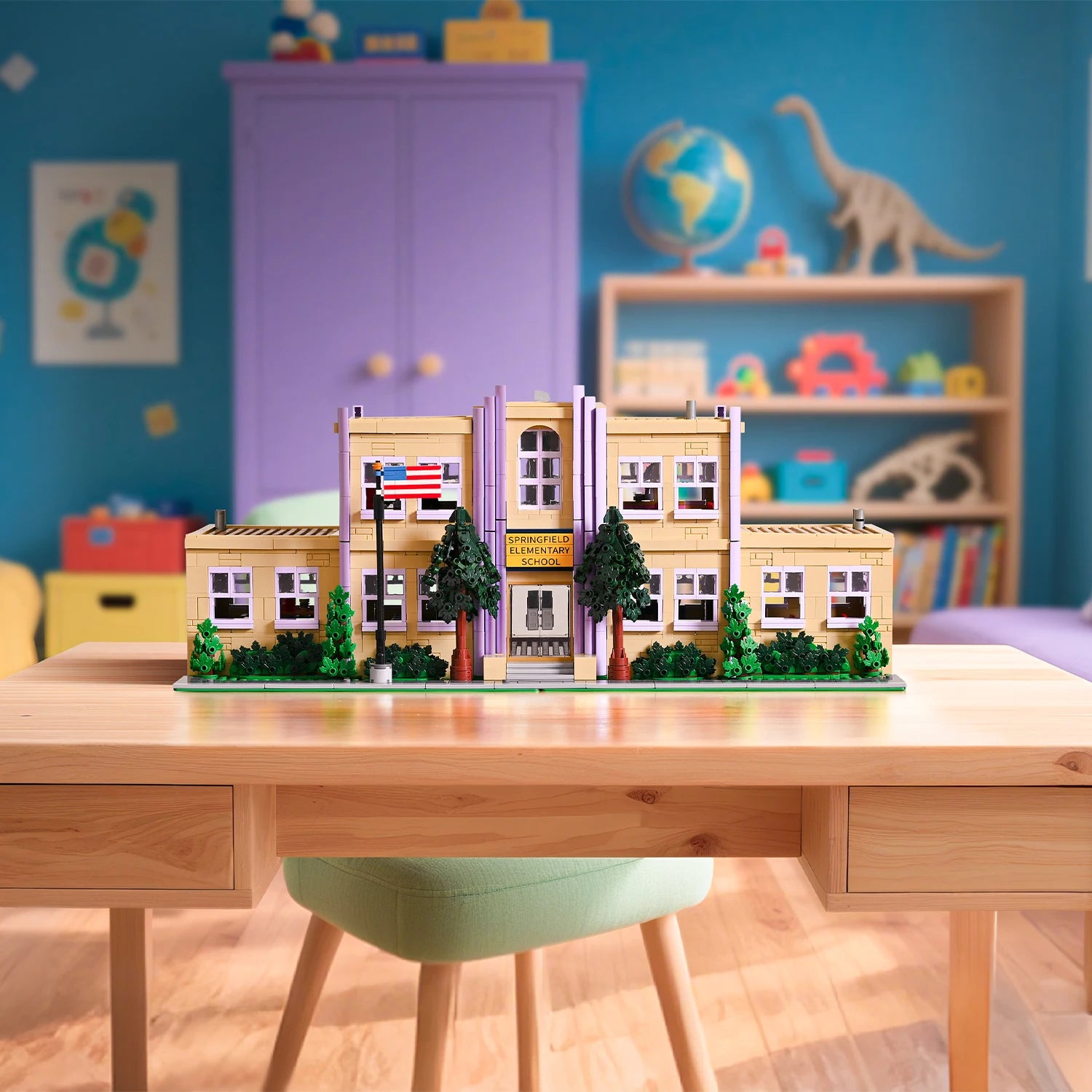 Model of a building on a desk with a colorful room in the background
